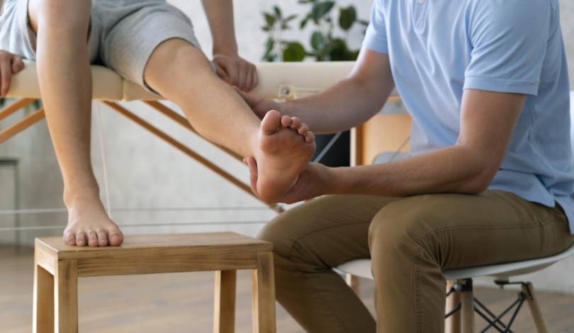 Patient receiving manual therapy for ankle ligament damage