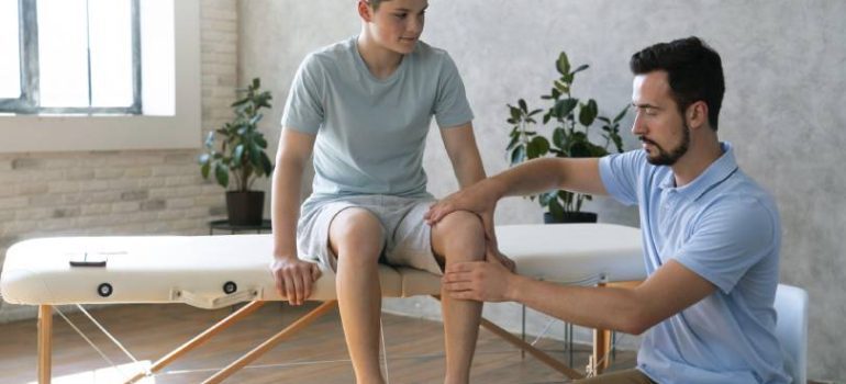 Patient receiving manual therapy for knee joint pain relief