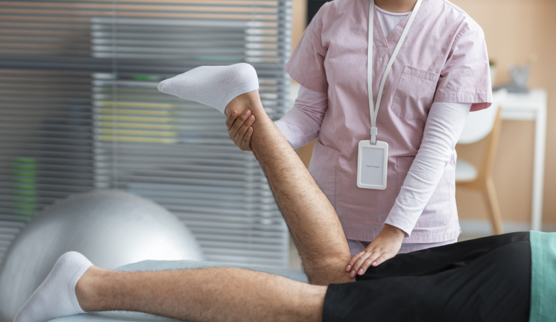 Physiotherapist guiding a patient through knee exercises