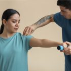 Physiotherapist assisting a patient with frozen shoulder exercises