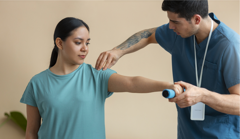 Physiotherapist assisting a patient with frozen shoulder exercises