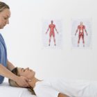 Physiotherapist guiding a patient through neck stretching exercises