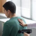 "Patient undergoing manual therapy for frozen shoulder treatment.